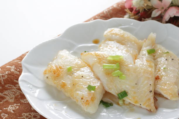 istock Pan fried flat fish fillet served with spring onion 1281238651