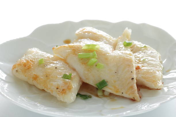 istock Pan fried flat fish fillet served with spring onion 1281238726