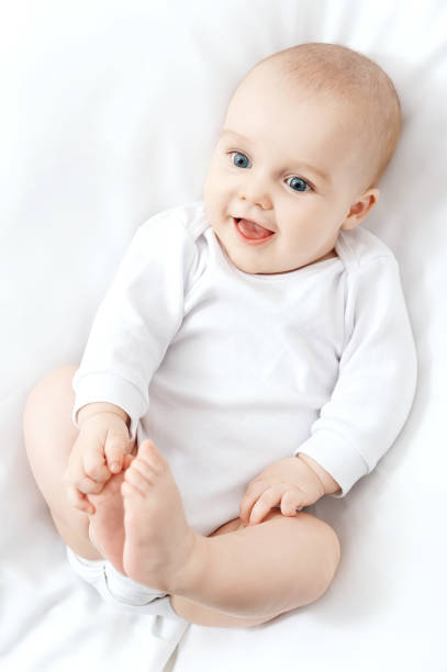 Little baby boy with a toy crawling on the floor at home