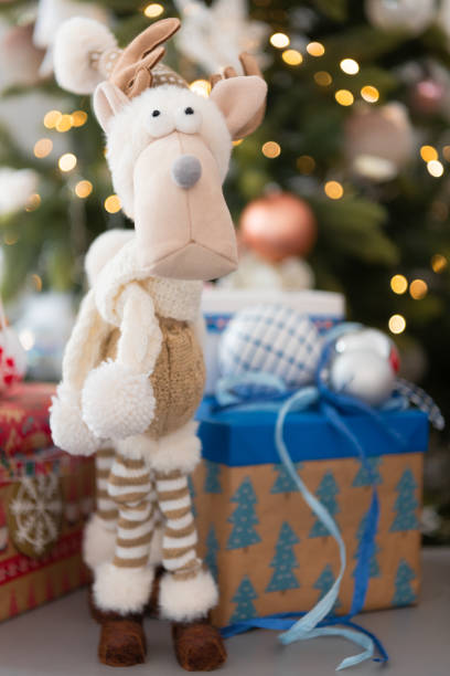 istock Reindeer funny, stands in front of the Christmas tree 1281241295
