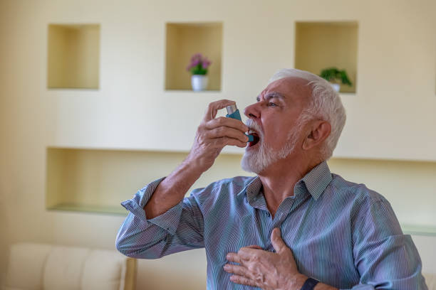 istock Senior Man with Asthma has Breathing Problems so he is Using an Inhaler. 1281241590