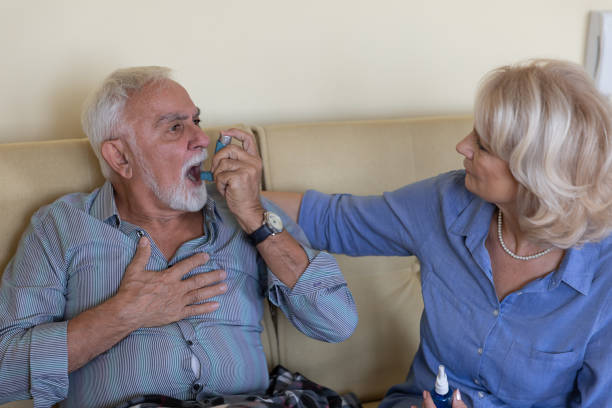 istock Senior Couple is Solving the Breathing Problems of an Older Man who is Using Inhaler. 1281241797