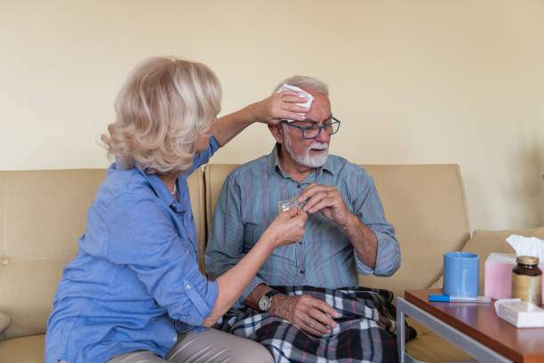 istock Older Woman is Helping her Sick Husband with Cold Virus. 1281241821