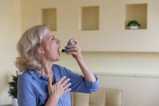 istock Senior Woman with Asthma is Using an Inhaler. 1281242079