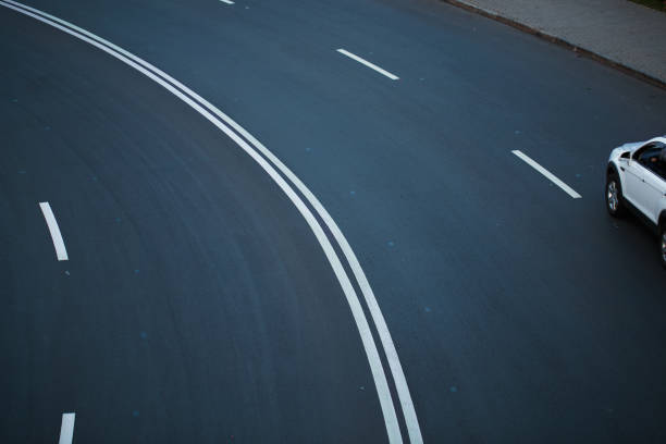 istock Road asphalt track with marks, turn line 1281244406
