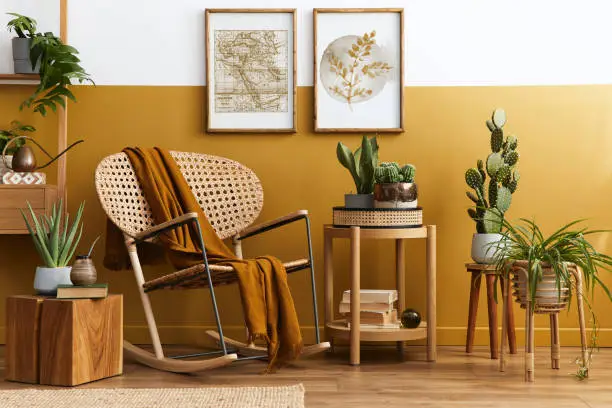 Stylish scandinavian interior of living room with design velvet sofa, furniture, plant and mock up poster frames. Template.