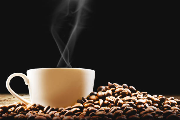 istock Cup of hot coffee with coffee beans on the table 1281247391