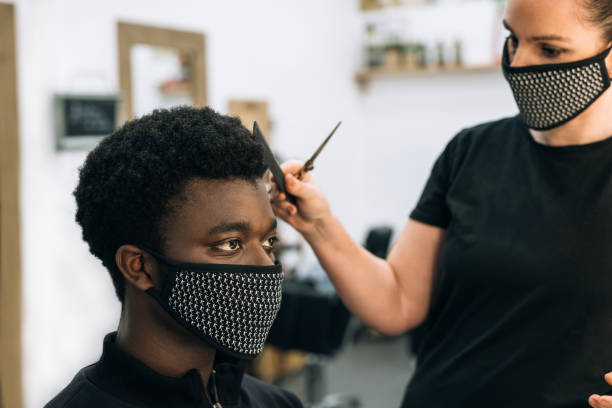 istock black guy in a hair salon with a coronavirus mask 1281248726