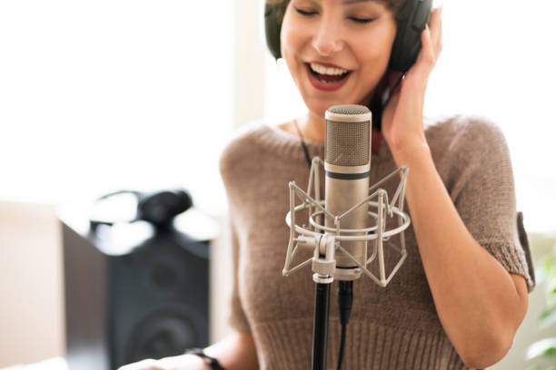 istock Caucasian, female singer singing eyes closed into the microphone 1281250014