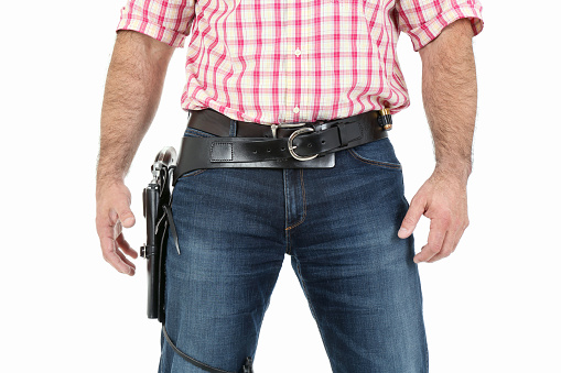 Gunslinger ready to duel, isolated on white background.