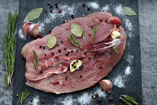 istock Fresh raw meat with spices and sea salt marinated on a stone board. 1281251472