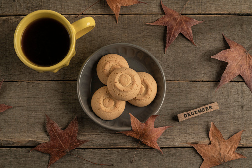 december template with coffee and cookies on a wooden table decorated dried leaves