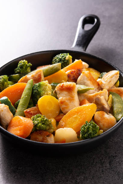 istock Stir fry chicken with vegetables on iron pan 1281252832