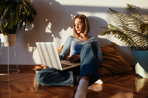 istock Young woman working on laptop at home 1281253391