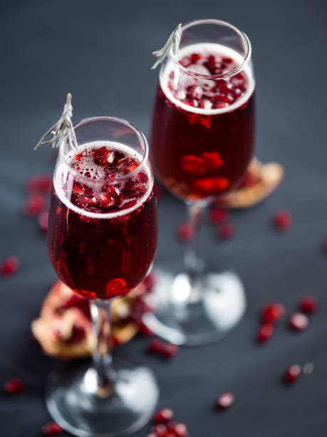 istock Christmas Mimosa cocktail with champagne and pomegranate on a dark table 1281254830