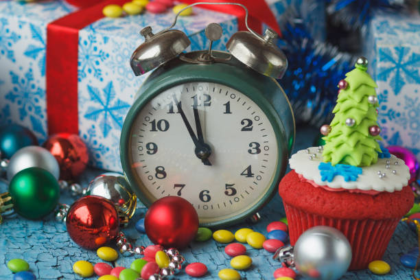 istock Christmas clock and cupcake with colored decorations 1281256339