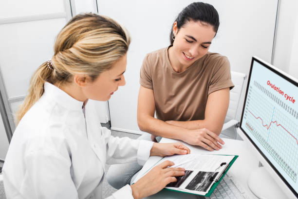 Patient woman receives consultation from her reproductive specialist. Gynecologist, pregnancy planning. Ovulation calendar and good days for fertilization Patient woman receives consultation from her reproductive specialist. Gynecologist, pregnancy planning. Ovulation calendar and good days for fertilization cervix photos stock pictures, royalty-free photos & images