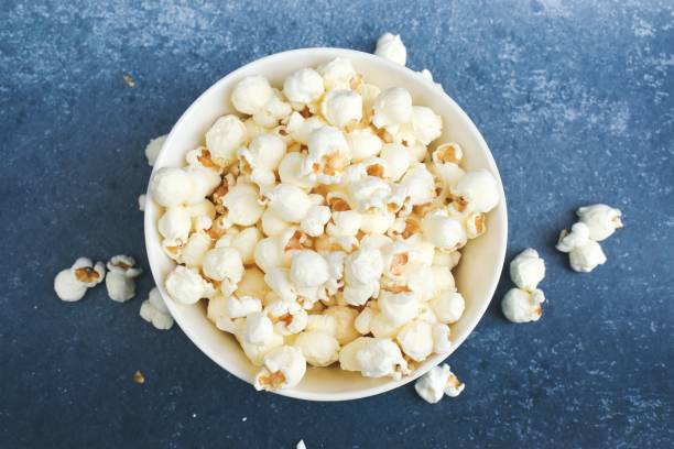istock Popcorns in a bowl on a blue background 1281257361
