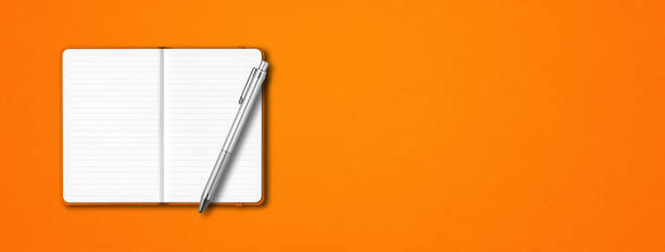 Orange open notebook with a pen isolated on colorful background. Horizontal banner Orange open lined notebook mockup with a pen isolated on colorful background. Horizontal banner moleskin stock pictures, royalty-free photos & images