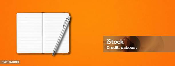 Orange Open Notebook With A Pen Isolated On Colorful Background Horizontal Banner Stock Photo - Download Image Now