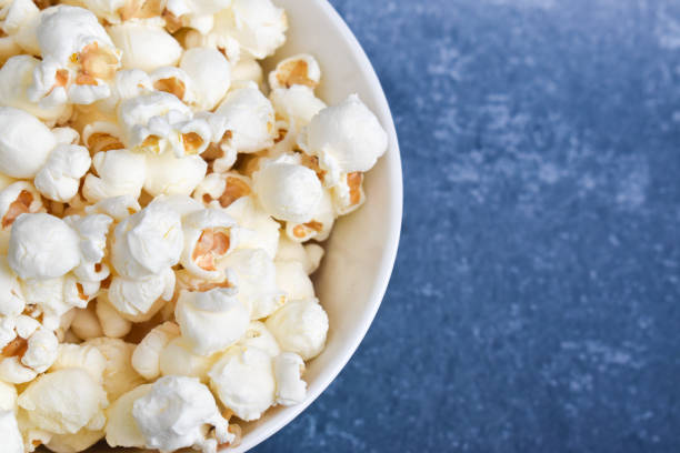 istock Popcorns in a bowl on a blue background 1281261596