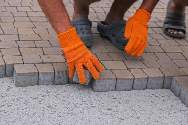 istock Construction worker installing and laying pavement stones on terrace. 1281261974
