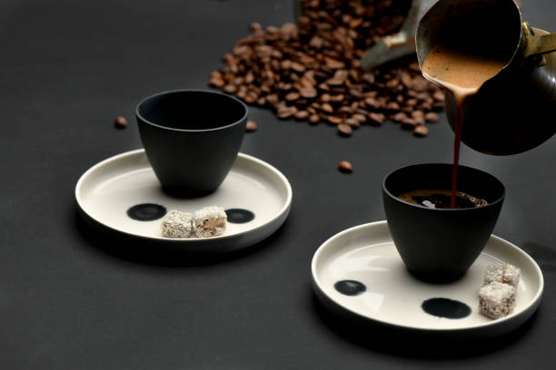 istock Hand Pouring Turkish Coffee over Black Background 1281265105