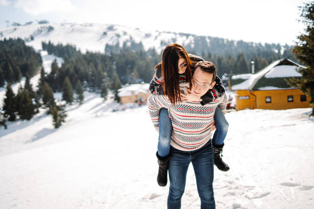 istock Playful couple having fun on snow 1281267015