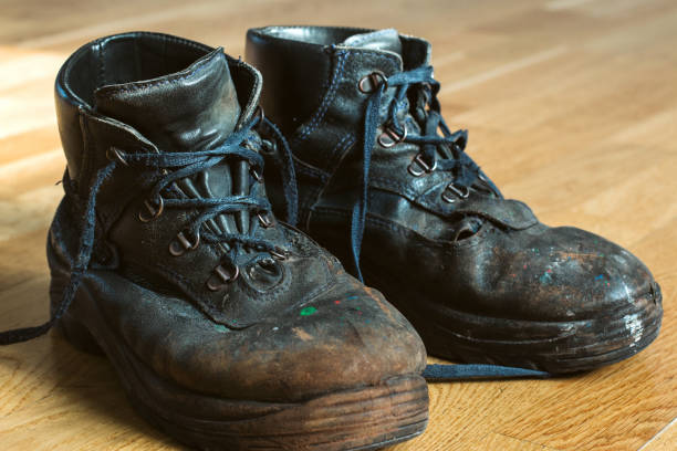 istock Old worn-out workman's shoes. Shoes that require repair or replacement 1281270659