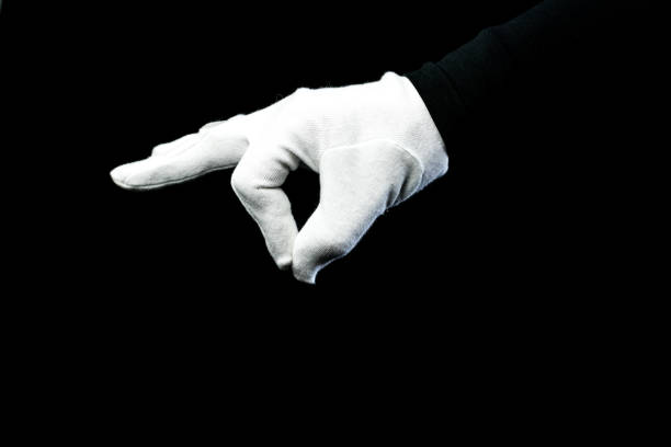 istock A hand wearing white glove on black background 1281272547
