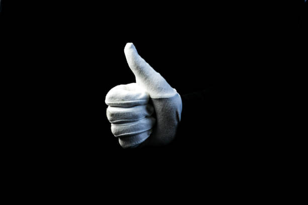 istock A hand wearing white glove on black background showing OK sign 1281272692