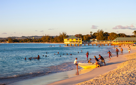 Bridgetown, Barbados - People enjoying sunset at popular Brownes Beach