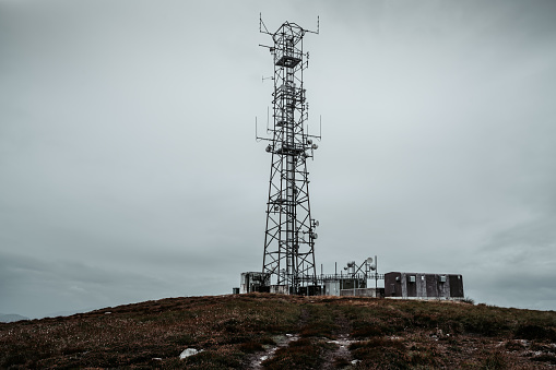 Cellular communications tower for mobile phone and video data transmission on the top of hill in Scotland.