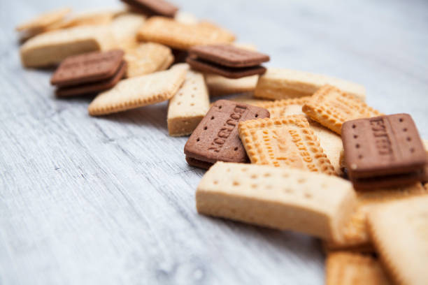 istock Close-up of British biscuits in a row on a rough wooden background with copy space 1281277219