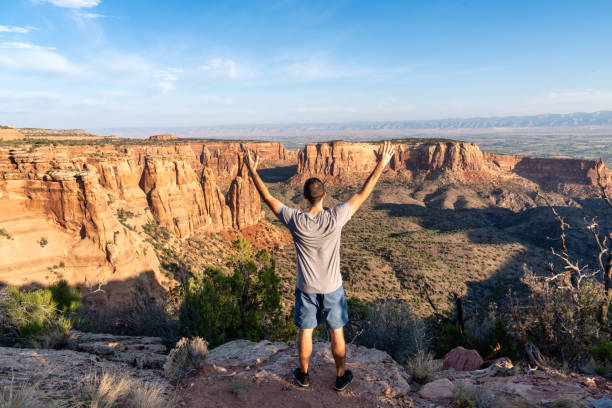 Tourist hiking in desert landscape Tourist hiking in desert landscape  - Colorado National Monument fruita colorado stock pictures, royalty-free photos & images
