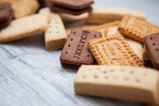 A British biscuit and shortbread selection arranged on a wooden board as a border background