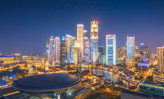 Singapore - 20 October 2022: Apple Marina Bay Sands with sunset sky. The World's First Floating Apple Store, designed by Foster + Partners.