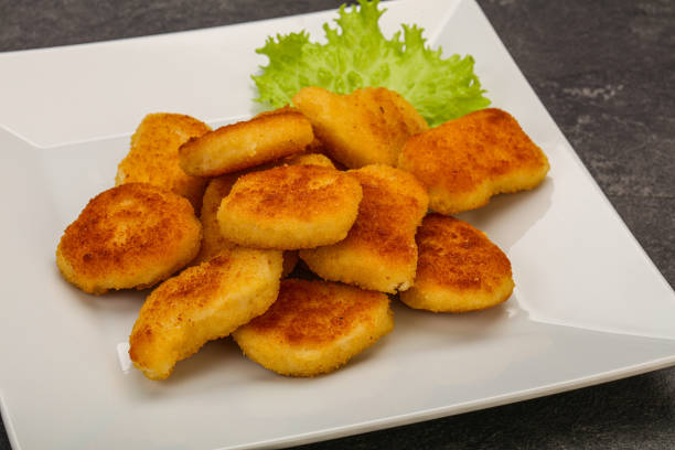 istock Fried chicken nuggets served salad leaves 1281284419