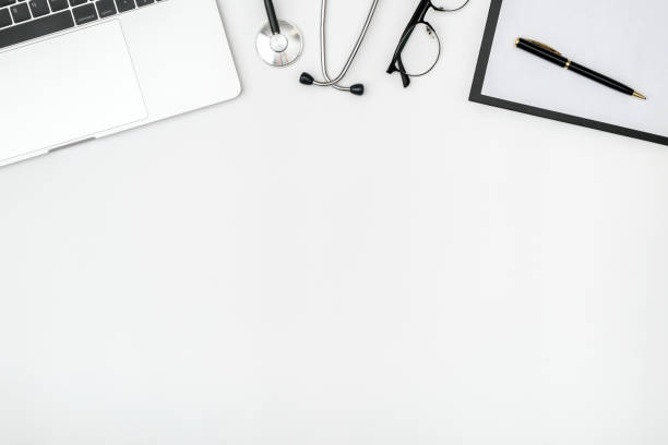 istock Workplace of modern doctor with laptop and stethoscope on white table. Top view. Flat lay 1281284948