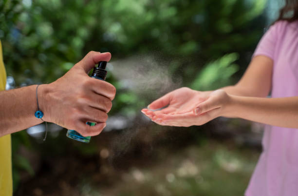 istock Father squirts antibacterial hand sanitizer in daughter's hands 1281286141