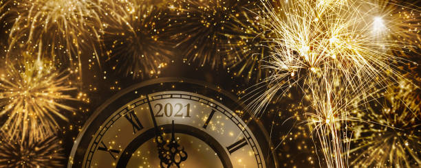 istock bautiful fireworks explosion for new years eve 2021 celebration, golden rockets at countdown clock at midnight 1281289094