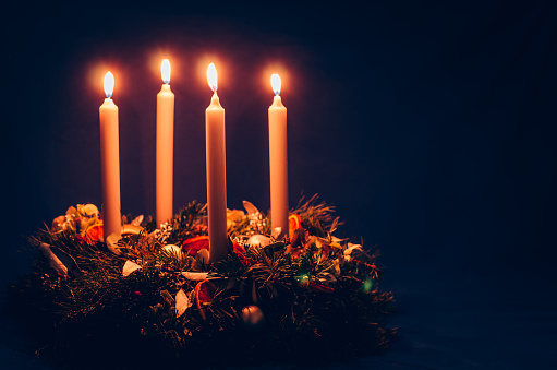 4 candle advent wreath on black background copy space