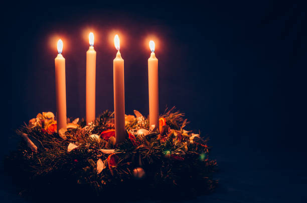 4. advent candle burning on advent wreath stock photo