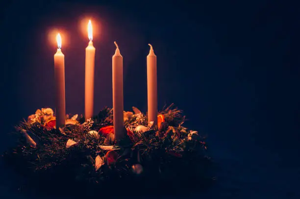 4 candle advent wreath on black background copy space