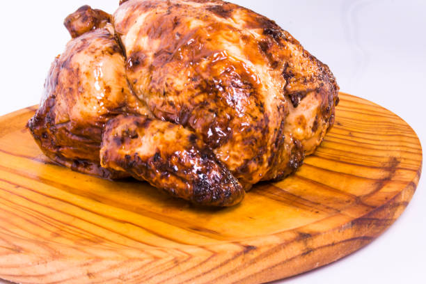 istock Roast chicken on a wooden tray on white background 1281292287