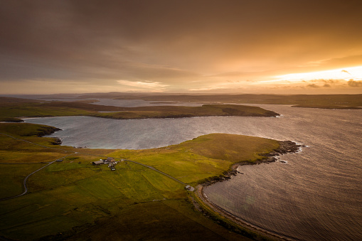 An aerial view of the coast at sunset in Westing on Unst Island, one of Scotland's northern Shetland Islands.