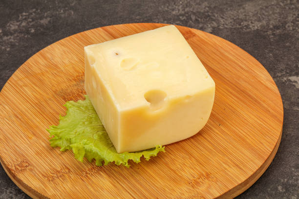 istock Emmental cheese over wooden board 1281295667