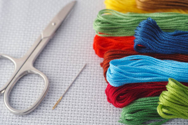 istock Colorful cross stitch embroidery threads with needle and scissors 1281297272