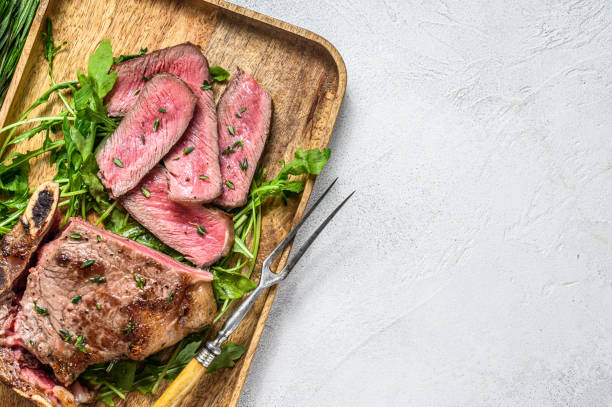 istock Sliced grilled Striploin beef meat steak. White background. Top view. Copy space 1281297394