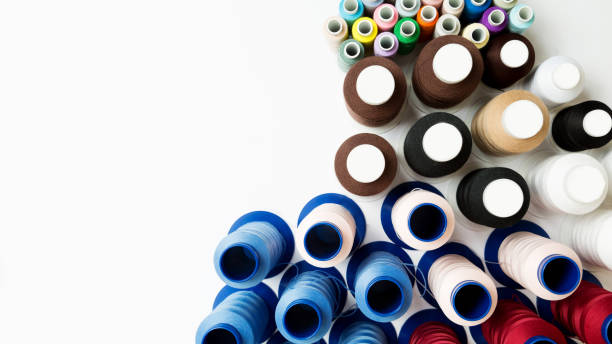 istock many small and large multicolored spools for sewing machine on the white background with copy space.Top view. Flat lay 1281300143